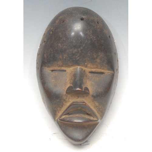 20 - Tribal Art - a Dan mask, domed forehead, narrow eyes, projecting features, 20.5cm long, Ivory Coast/... 