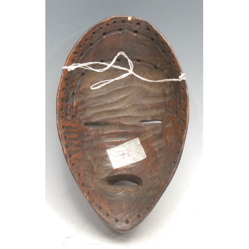 20 - Tribal Art - a Dan mask, domed forehead, narrow eyes, projecting features, 20.5cm long, Ivory Coast/... 