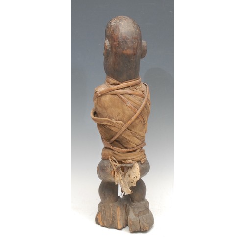 40 - Tribal Art - a Kongo/Yaka zoomorphic nkisi power figure, simian features, cloth wrapped, 46cm high, ... 