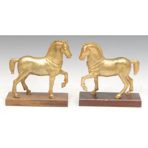 980 - A pair of gilt bronzes, the Horses of Saint Mark, after the Antique, wooden bases, 18cm high each