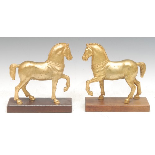 980 - A pair of gilt bronzes, the Horses of Saint Mark, after the Antique, wooden bases, 18cm high each