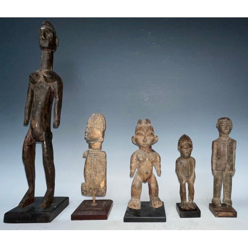 51 - Tribal Art - a Lobi colon figure, he stands, wearing European military uniform, 22cm high, Burkina F... 