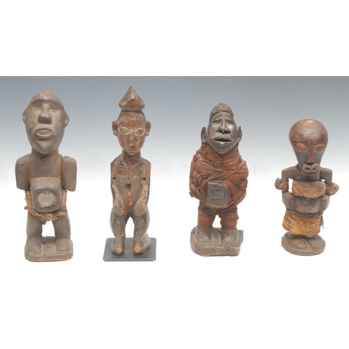 34 - Tribal Art - a Kongo nkisi power figure, the eyes and niche set with glass fragments, cloth bound, 2... 