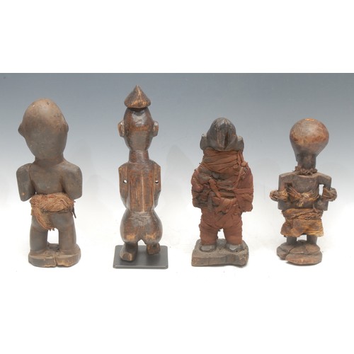 34 - Tribal Art - a Kongo nkisi power figure, the eyes and niche set with glass fragments, cloth bound, 2... 