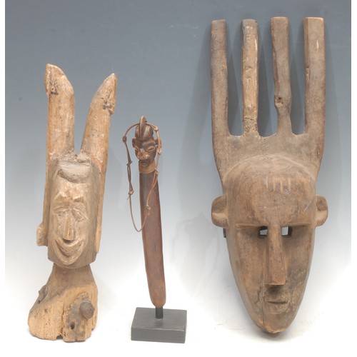 4 - Tribal Art - a Bambara Ntomo mask, 41cm long, Mali; a janus head puppet, 33.5cm high; a Yaka figural... 