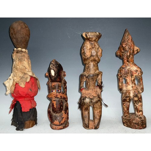 77 - Tribal Art - a Senufo figure, of typical pose, fragmentary red surface pigment, 30cm high, Ivory Coa... 