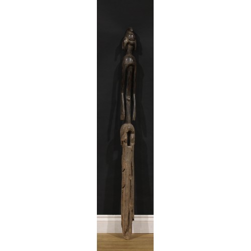 46 - Tribal Art - a large Mumuye figure or house marker, of typical elongated form, 136cm high, Nigeria