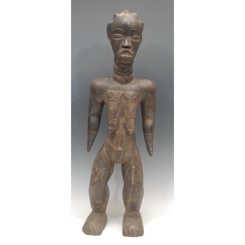 19 - Tribal Art - a Dan female figure, she stands, with elongated neck, metal teeth, 66cm high, Ivory Coa... 