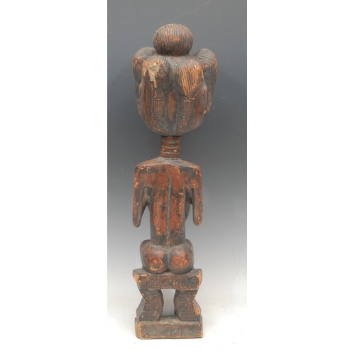 54 - Tribal Art - a Luba female figure, elaborate coiffure, seated on a stool , traces of red pigment to ... 