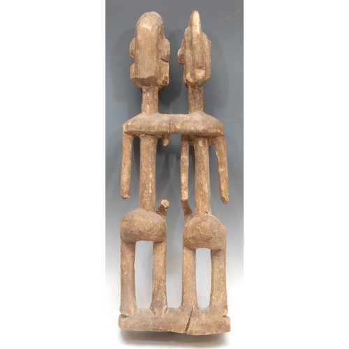 22 - Tribal Art - a Dogon figural carving, depicting the primordial couple, 59cm high, Mali, West Africa