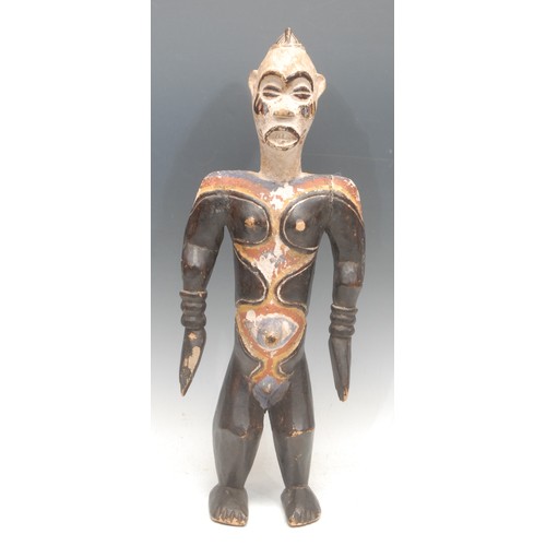 104 - Tribal Art - an Idoma figure, depicted standing, decorated in polychrome with bold geometric motifs,... 