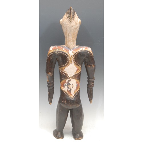 104 - Tribal Art - an Idoma figure, depicted standing, decorated in polychrome with bold geometric motifs,... 