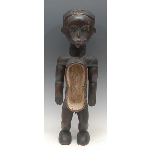 100 - Tribal Art - an African reliquary power figure, probably Fang, depicted standing, the elongated body... 