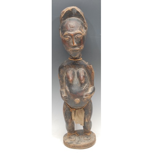 8 - Tribal Art - a Baule female figure, elaborate coiffure, scarified, 49cm high, Ivory Coast