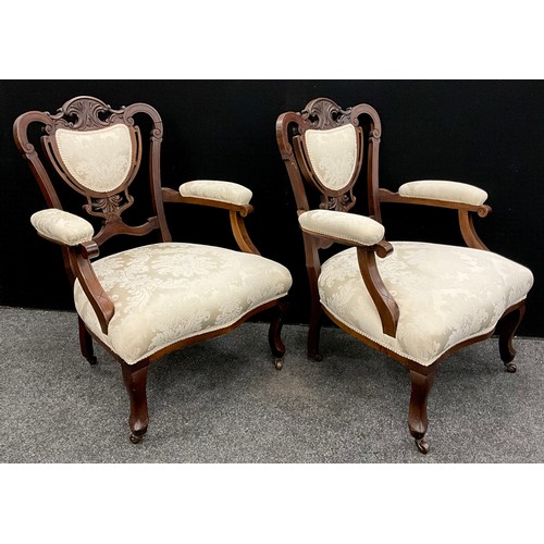 23 - A pair of Victorian carved mahogany armchairs, c.1890, 94.5cm high x 72cm wide, (2).