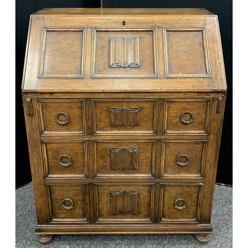 28 - An Old Charm style carved oak bureau, 97cm high x 73.5cm wide x 41cm deep.