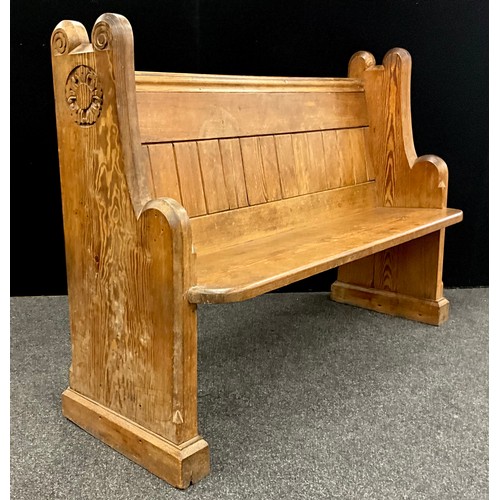 36 - A 19th century pitch pine church pew, carved with a rose to each end, bible shelf to back, 97cm high... 