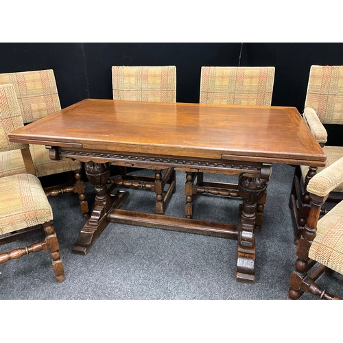 40 - A Jacobean revival carved oak draw leaf dining table, and set of six Titchmarsh and Goodwin style up... 