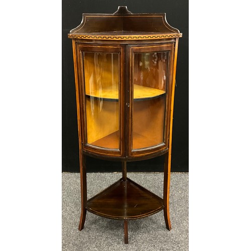 64 - An Edwardian inlaid mahogany bow-front corner cabinet, galleried top, with ebony and boxwood Greek k... 