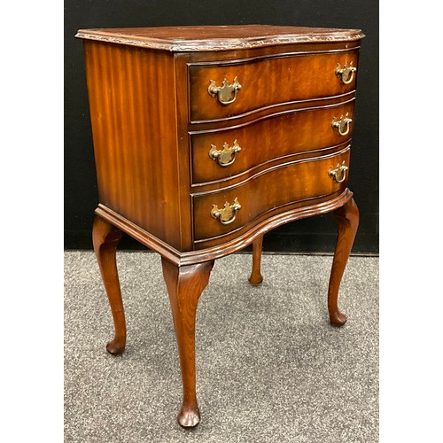 77 - Furniture - a George III revival inverted serpentine front mahogany side cabinet, having three short... 