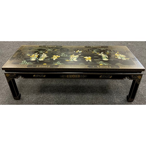 79 - A Chinoiserie black lacquer-work effect coffee table, painted to the top with musicians and ladies w... 