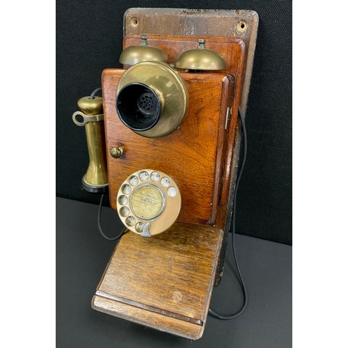 89 - An early 20th century mahogany cased wall mounted telephone.