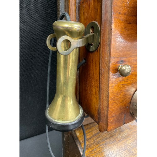 89 - An early 20th century mahogany cased wall mounted telephone.