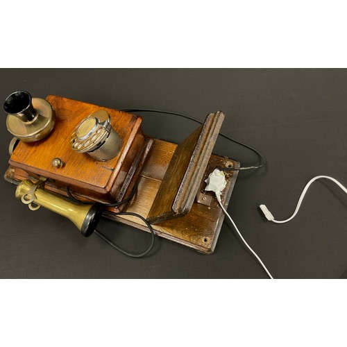 89 - An early 20th century mahogany cased wall mounted telephone.