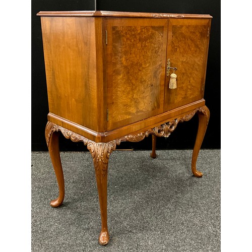 91 - A Walnut drinks cabinet, fitted interior, with original retro cocktail sticks, and brass serving tra... 