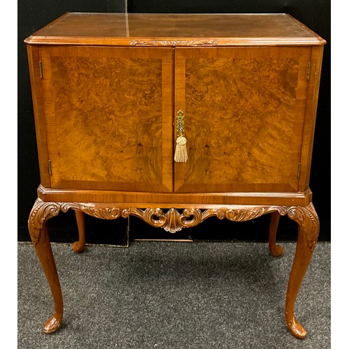 91 - A Walnut drinks cabinet, fitted interior, with original retro cocktail sticks, and brass serving tra... 