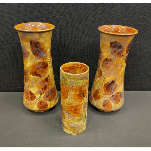 114 - A pair of Royal Doulton stoneware Autumn Leaves foliate ware waisted vases,  24cm high, another smal... 