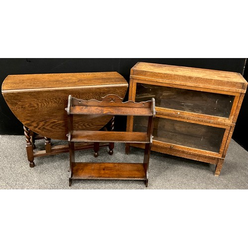 241 - A mid 20th century oak Globe Wernicke style two tier sectional bookcase;  an elm wall shelf;  oak dr... 