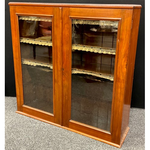 244 - An Edwardian mahogany bookcase cabinet, the pair of glazed doors enclosing three tiers of mahogany s... 