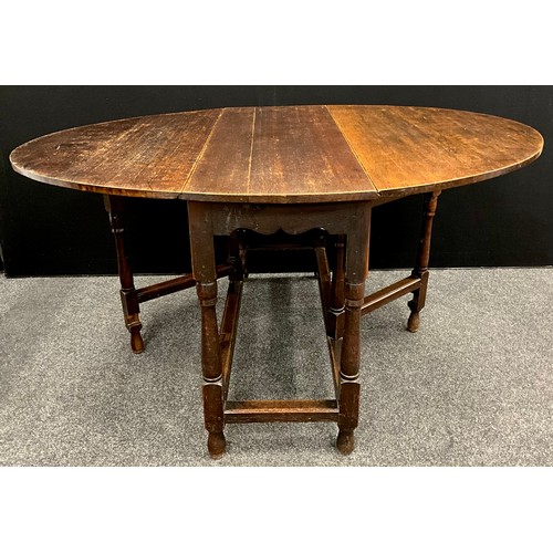 192A - A 19th century oak drop leaf table, oval top, turned supports, peg joints, 151.5cm x 122cm open (43.... 