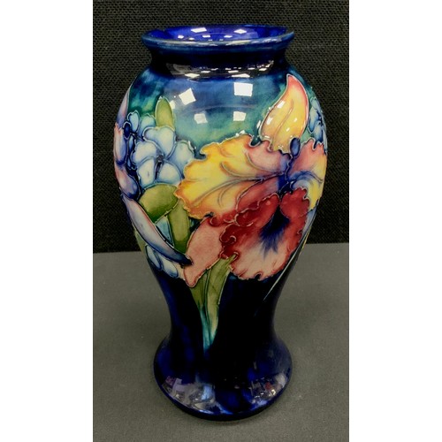 8 - A Moorcroft pottery inverted baluster-shaped vase, tube lined with the Orchid pattern, blue ground, ... 