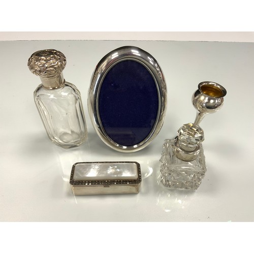 323 - A mother of pearl and marcasite topped rectangular pill box;  silver bud vase;  two silver topped dr... 