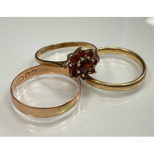 425 - Rings - garnet cluster ring, 9ct gold shank, size P, 1.8g gross;  two 9ct gold wedding bands, both s... 