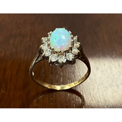 438 - An opal and Cubic zirconia oval dress ring, 9ct old shank, size M, 2.4g gross