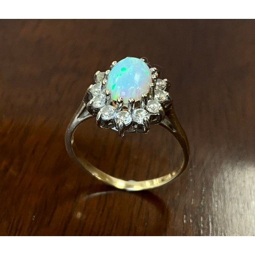 438 - An opal and Cubic zirconia oval dress ring, 9ct old shank, size M, 2.4g gross