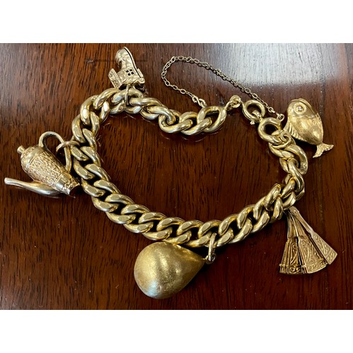 442 - An 18ct gold charm bracelet with five charms, fan, fish, coffee pot etc.  Part stamped 750, part unm... 