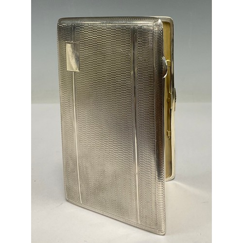 61 - A George VI silver cigarette case, machined body, gilt interior, 12.5cm x 8.5cm, Birmingham 1946, 19... 