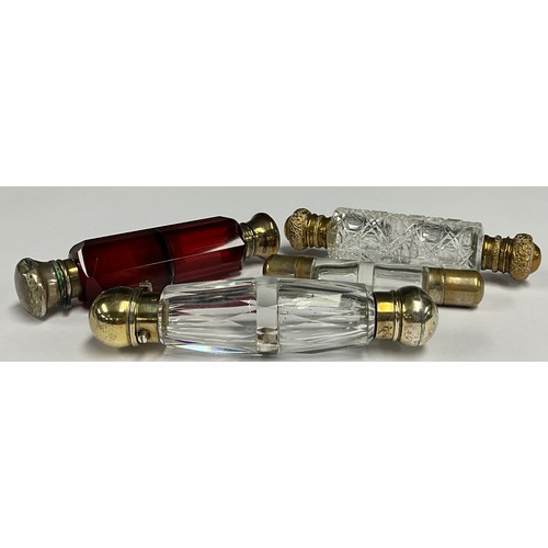 66 - A Victorian/Edwardian facetted ruby glass double ended scent bottle, 11.5cm long; a gilt metal mount... 