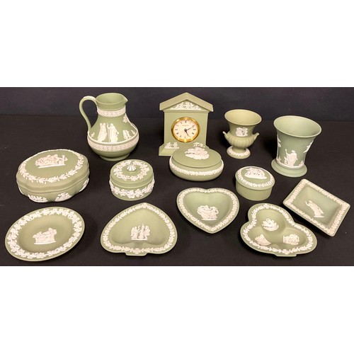 72 - A quantity of Wedgwood green Jasperware, including pill boxes, clock, trumpet vase, urn, jug, trinke... 