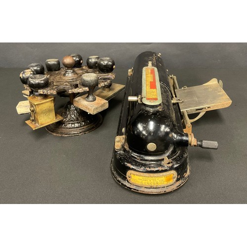 122 - An early 20th century cast iron counter or desk top revolving seal stand, a selection of seals en su... 