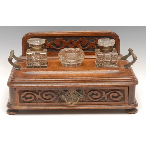 124 - A Victorian oak desk stand, galleried back, pair of glass lidded inkwells, central glass dish, drawe... 