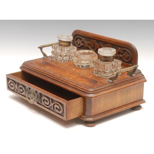 124 - A Victorian oak desk stand, galleried back, pair of glass lidded inkwells, central glass dish, drawe... 