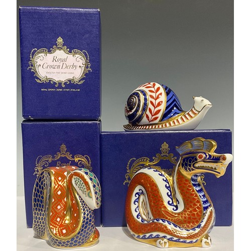 304 - A Royal Crown Derby paperweight, Dragon, gold stopper, boxed; others, Snake, gold stopper, boxed; Sn... 