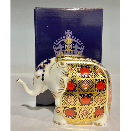 12 - A Royal Crown Derby paperweight, Elephant, with trunk raised, decorated in the 1128 Imari palette, p... 