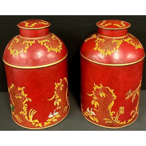 333 - A pair of reproduction red toleware style tea canisters painted with chinoiserie style decoration, 3... 