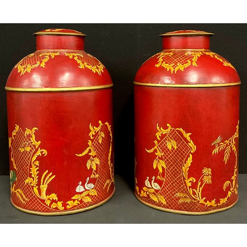 333 - A pair of reproduction red toleware style tea canisters painted with chinoiserie style decoration, 3... 